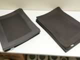 two napkins on a white table next to each other
