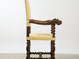 an old wooden chair with a yellow leather seat on a white background