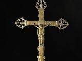 a gold cross with a crown on top of it