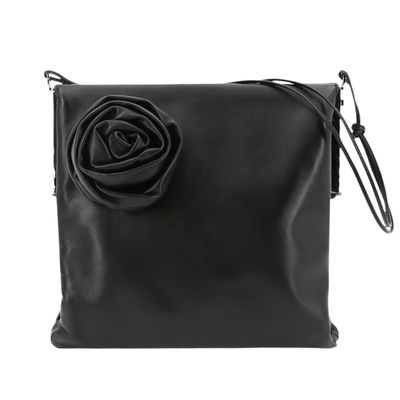 a black purse with a rose on the front