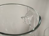 a broken glass pitcher sitting on a table