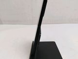 the tablet is sitting on top of the stand on the table