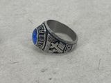 a close up of a ring with a blue stone in it