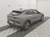a grey car is parked in a garage with a checkered floor