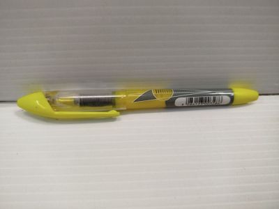 un stylo jaune posé sur une surface blanche