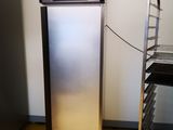 a stainless steel refrigerator in the corner of a room