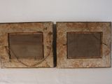 two wooden frames with a mirror on them on a white surface