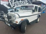 a white jeep that is parked in front of a building