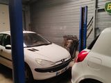 two cars parked in a garage next to each other