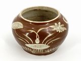 a brown and white vase with flowers on it