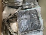 a cardboard box full of pillows and blankets in it