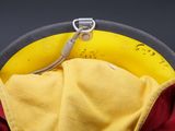 a close up of a yellow and red hat with a yellow hat on it