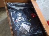 a cardboard box with a black shirt inside of it