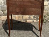a small wooden table with a drawer on top of it