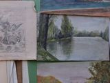 many paintings on the wall of this room