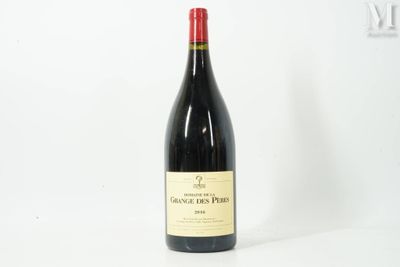 a bottle of red wine sitting on top of a white table