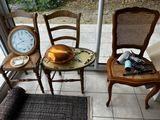 three chairs and a table with a clock on it