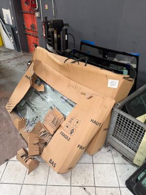 a pile of cardboard and other items on the floor