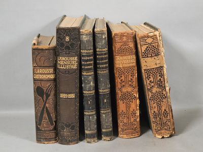 several old books are stacked on top of each other on a table