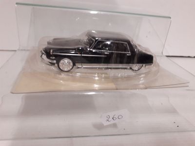 a black car in a clear case on a table