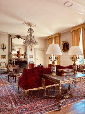 a living room with a lot of furniture and a chandelier