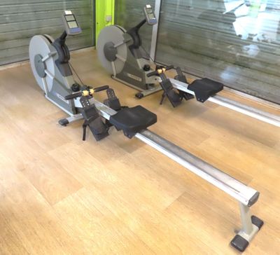 two stationary exercise bikes in a gym room