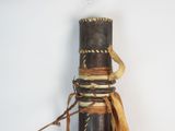 a small wooden object with a brown ribbon on it