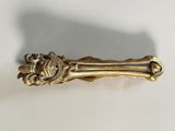 a gold colored hair clip with a lion head on it