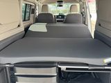 a bed in the back of a van with a mattress on it