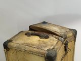 an old suitcase sitting on top of a wooden table
