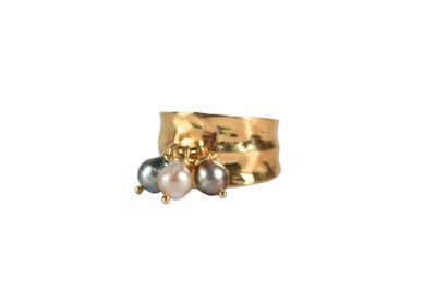 an image of a gold ring with two pearls on it