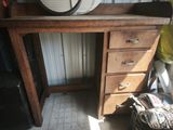 a wooden desk with a clock on top of it
