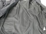 the back of a gray jacket with a zipper on it
