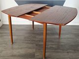 a wooden table with two leaves on top of it
