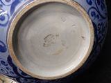 a blue and white vase sitting on top of a table