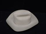 a white hat sitting on top of a white plate