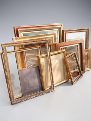 a lot of picture frames sitting on a table