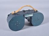 a small blue suitcase with a wooden handle on a white surface