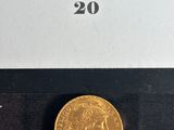 a gold coin with a picture of a woman on it