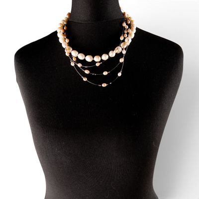 a close up of a mannequin torso with a necklace on it