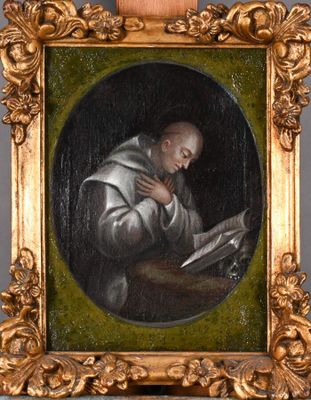 un vieux tableau représentant un homme en train de lire un livre, dans un cadre doré