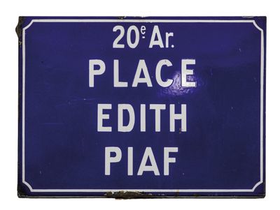 blue sign with white writing on it stating 20 a t place edith piaf