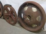 two old wheels sitting next to each other on the ground