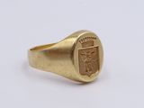 a close up of a gold signet ring with a coat of arms on it