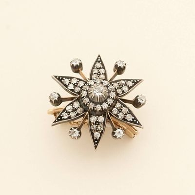 a close up of a ring with diamonds on a white surface