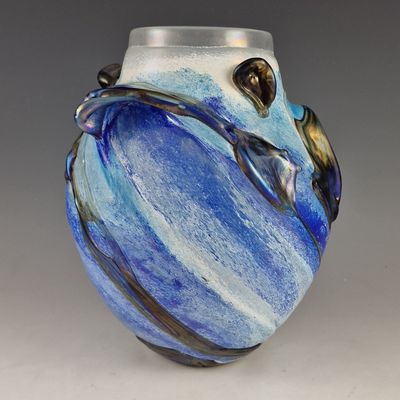 a blue and white vase that is sitting on a table