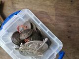 a plastic container filled with coins and a pair of scissors