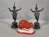 three figurines of a rat and a statue of a woman