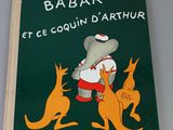 a green book with a picture of a man and a kangaroo on it