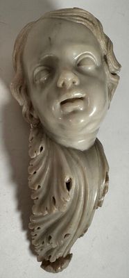 a small statue of a child with a smile on it ' s face